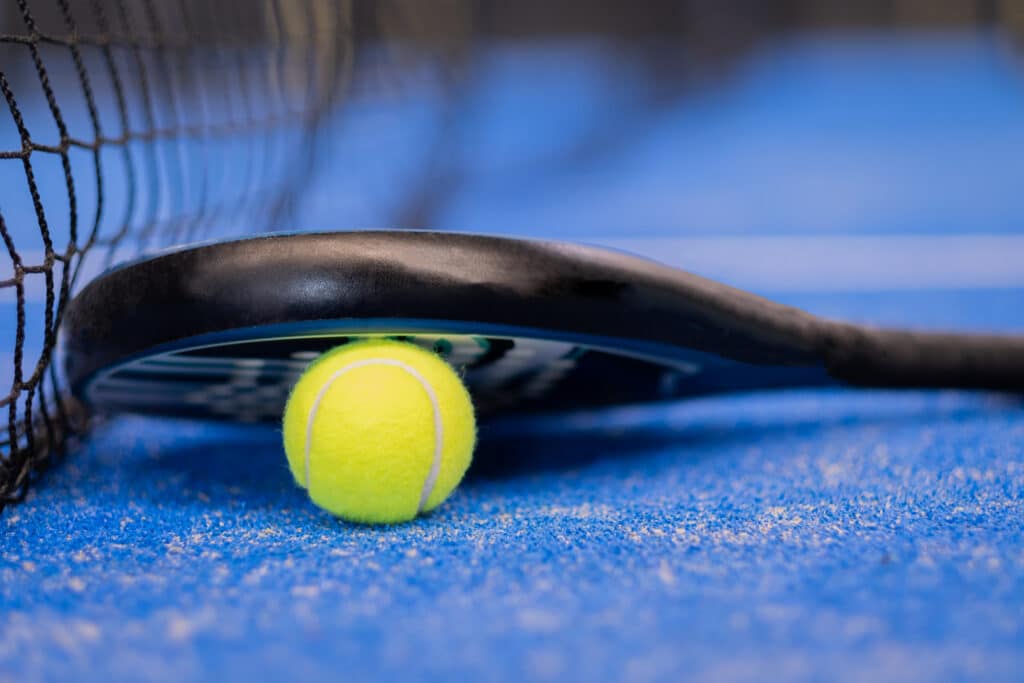 Close up padel or tennis racket and ball